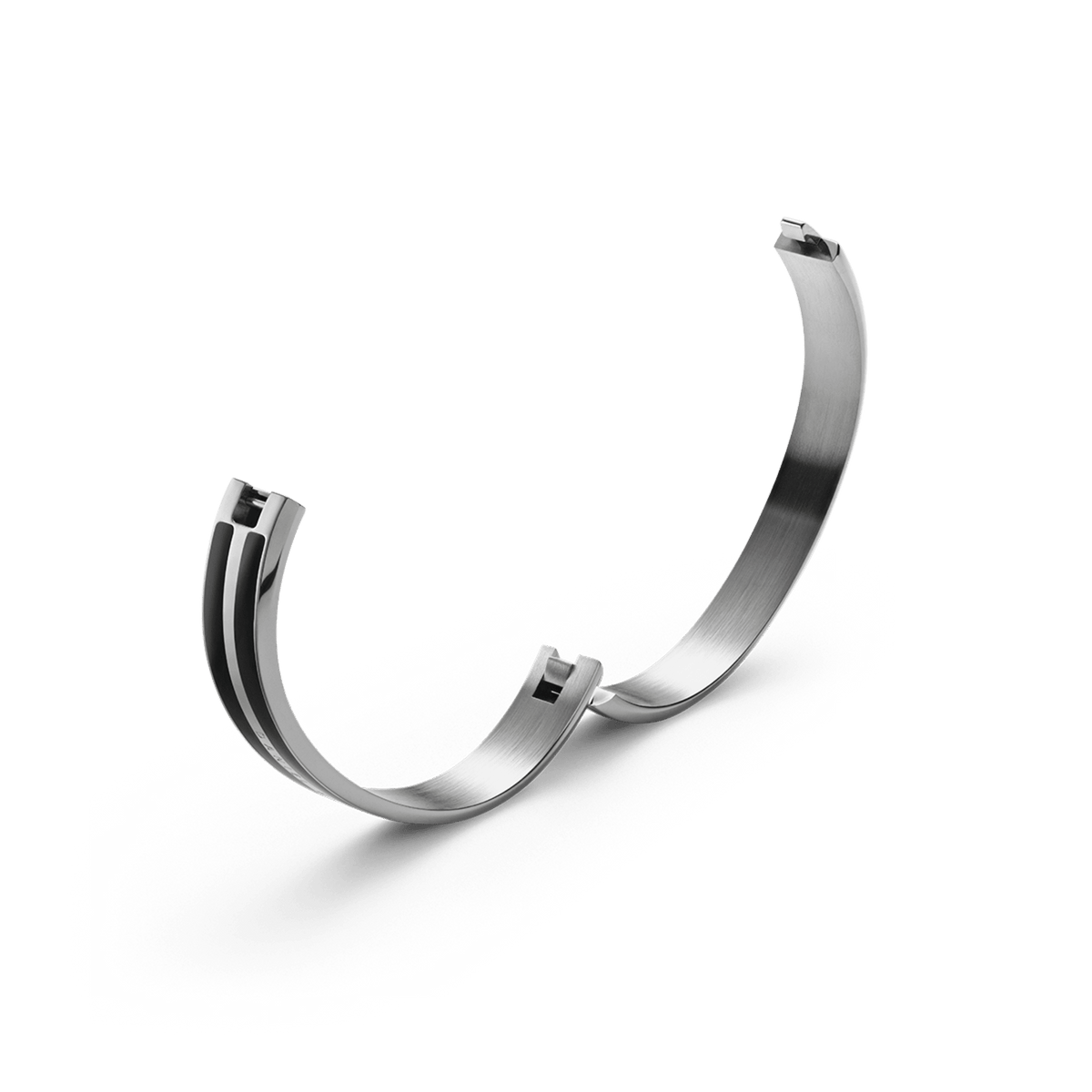 Open Emalie Infinite Silver Black bangle by Daniel Wellington, displaying the concealed seamless clasp and polished stainless steel interior with black enamel detailing.