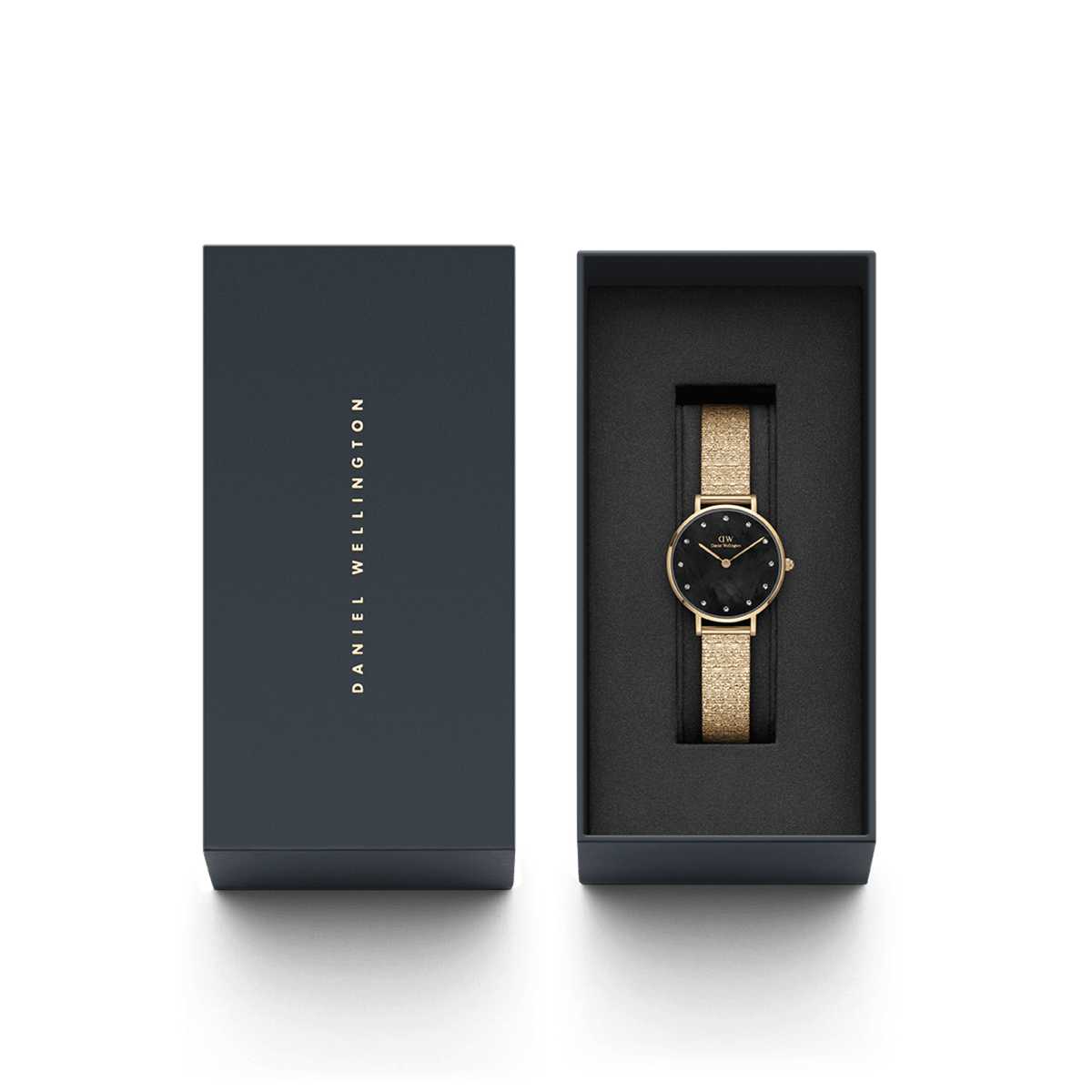 Petite Lumine Pressed Piano Gold women’s watch with black dial in Daniel Wellington gift box, gold mesh strap visible.