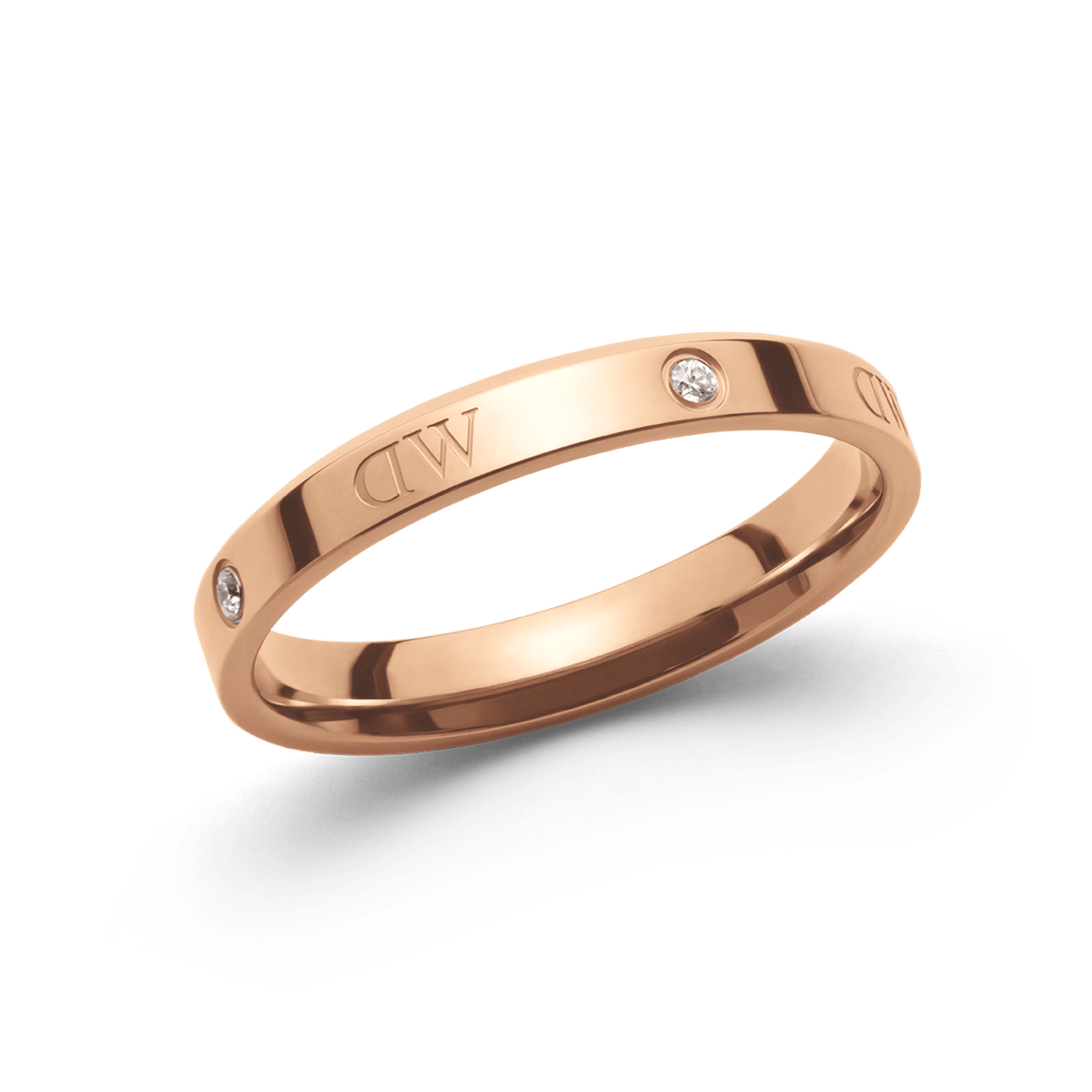 Slender rose gold ring featuring alternating crystal stones and subtle engraved detailing, finished with a polished shine.