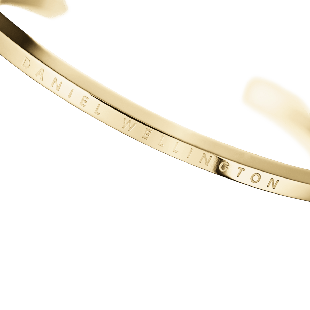 Close-up of the Classic Bracelet Gold by Daniel Wellington, highlighting the polished gold finish and engraved logo detail.