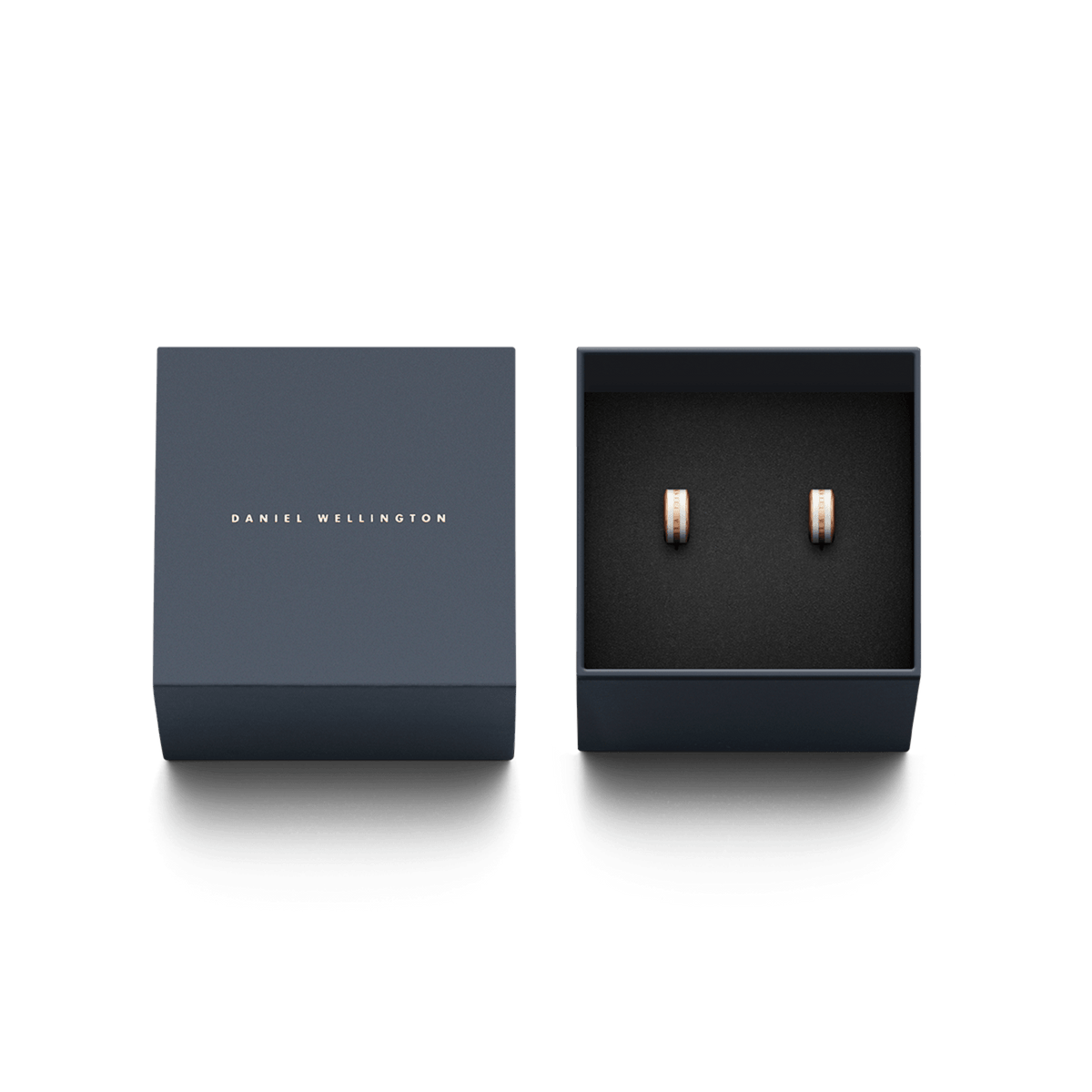 Emalie Earrings Rose Gold Satin White presented in a navy Daniel Wellington gift box, showcasing the elegant rose gold hoops with satin white enamel inlay.