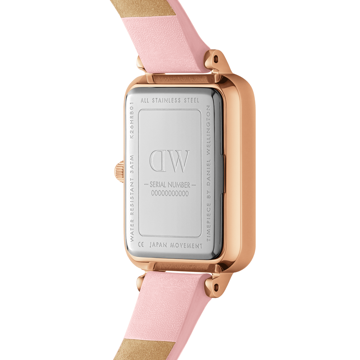 Close-up of the back of the Daniel Wellington Quadro Cherry Blossom watch, showing the stainless steel case, engraved branding, and pastel pink Italian leather strap.