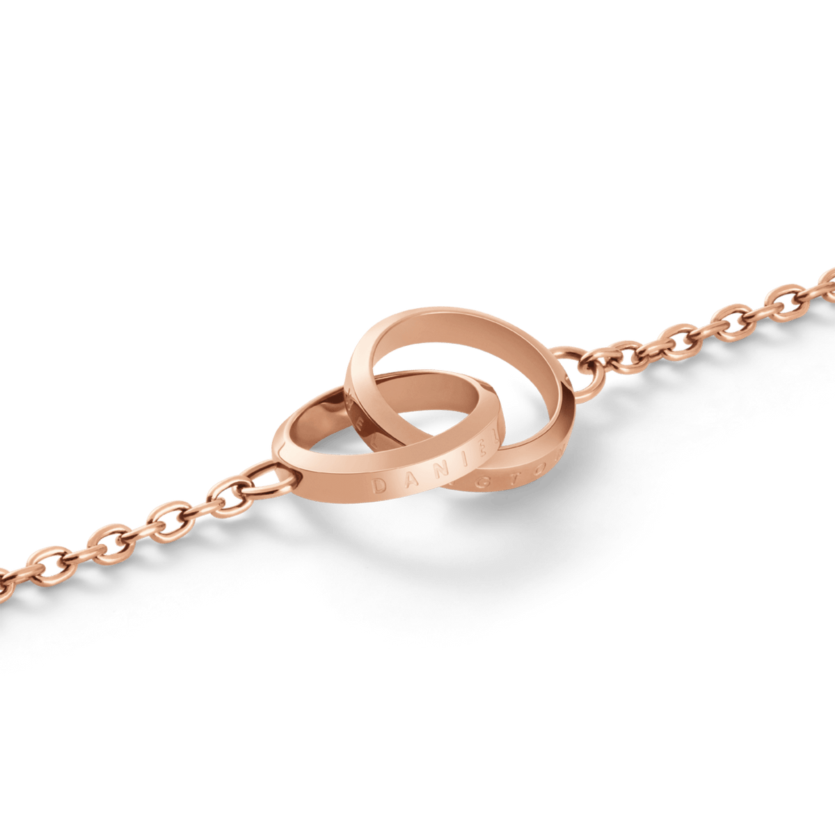 Close-up of the Elan Unity Bracelet in rose gold, showing two interlocking engraved rings on a fine chain.