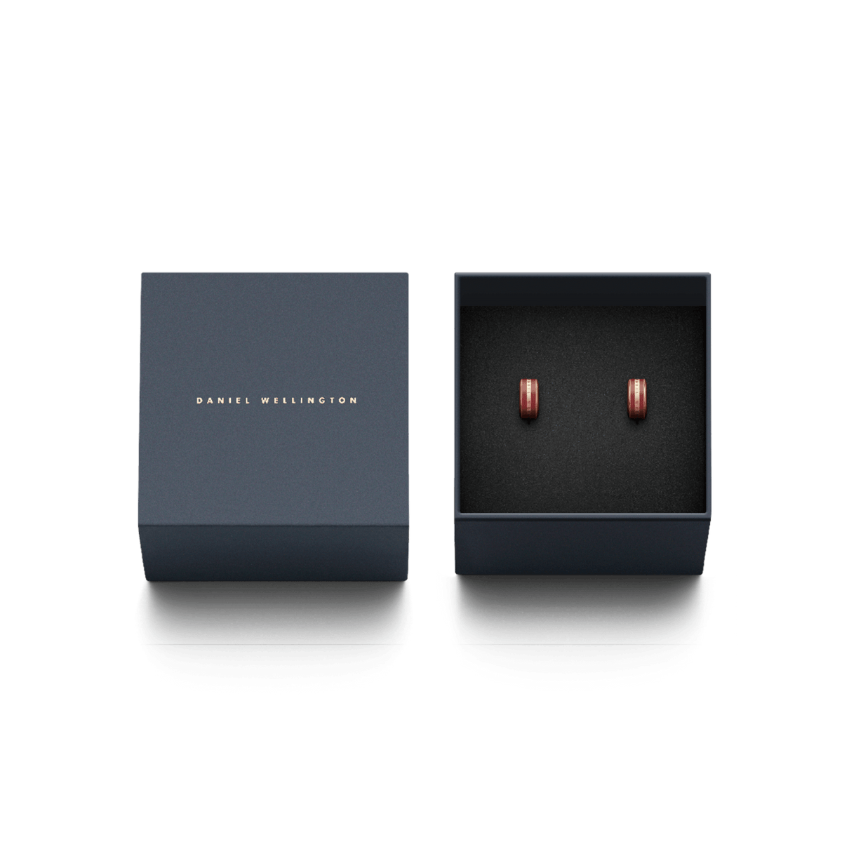 Pair of Emalie rose gold and cherry blush enamel hoop earrings presented in an elegant navy Daniel Wellington gift box.