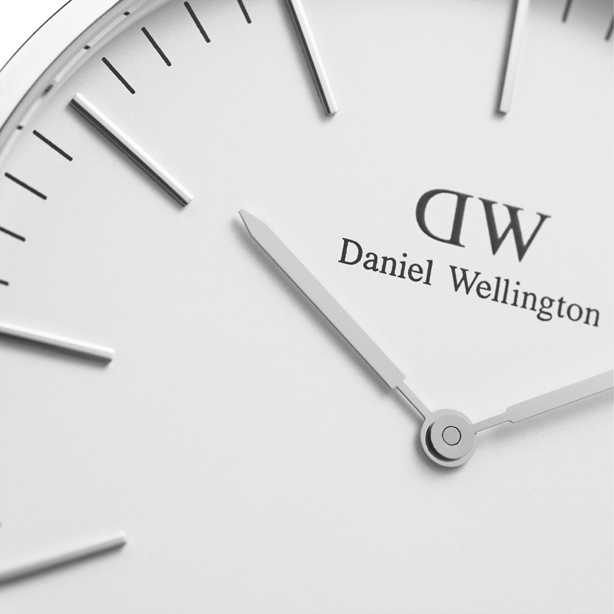 Detail of Classic Sheffield Silver watch face with minimalist white dial, silver hands and Daniel Wellington branding.