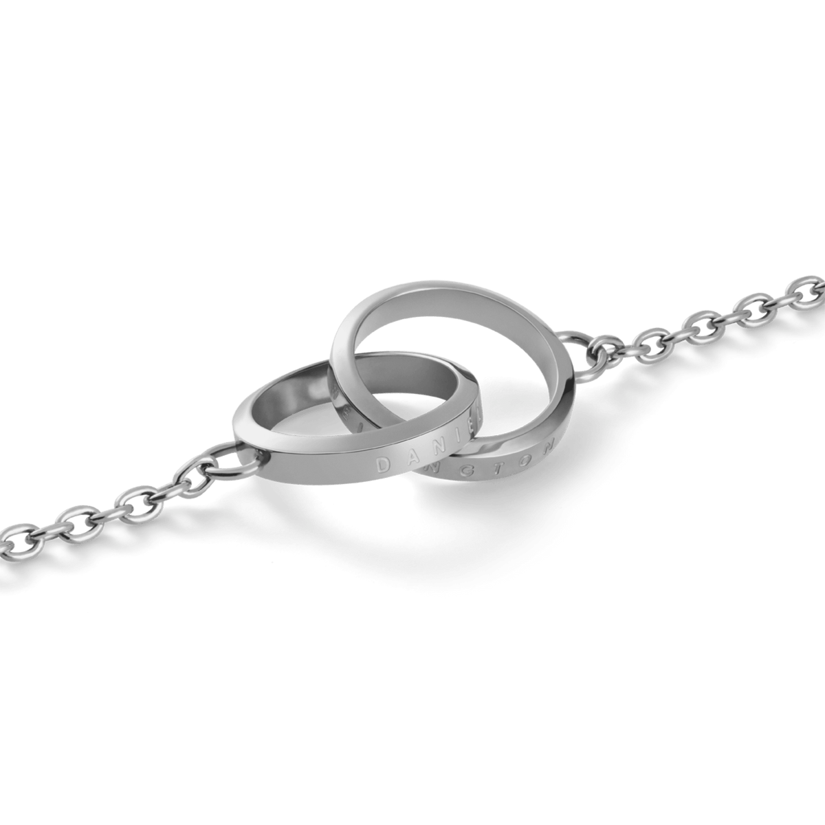 Close-up of the Elan Unity Necklace Silver, featuring two polished interlocking rings with subtle Daniel Wellington engraving on a fine silver chain.