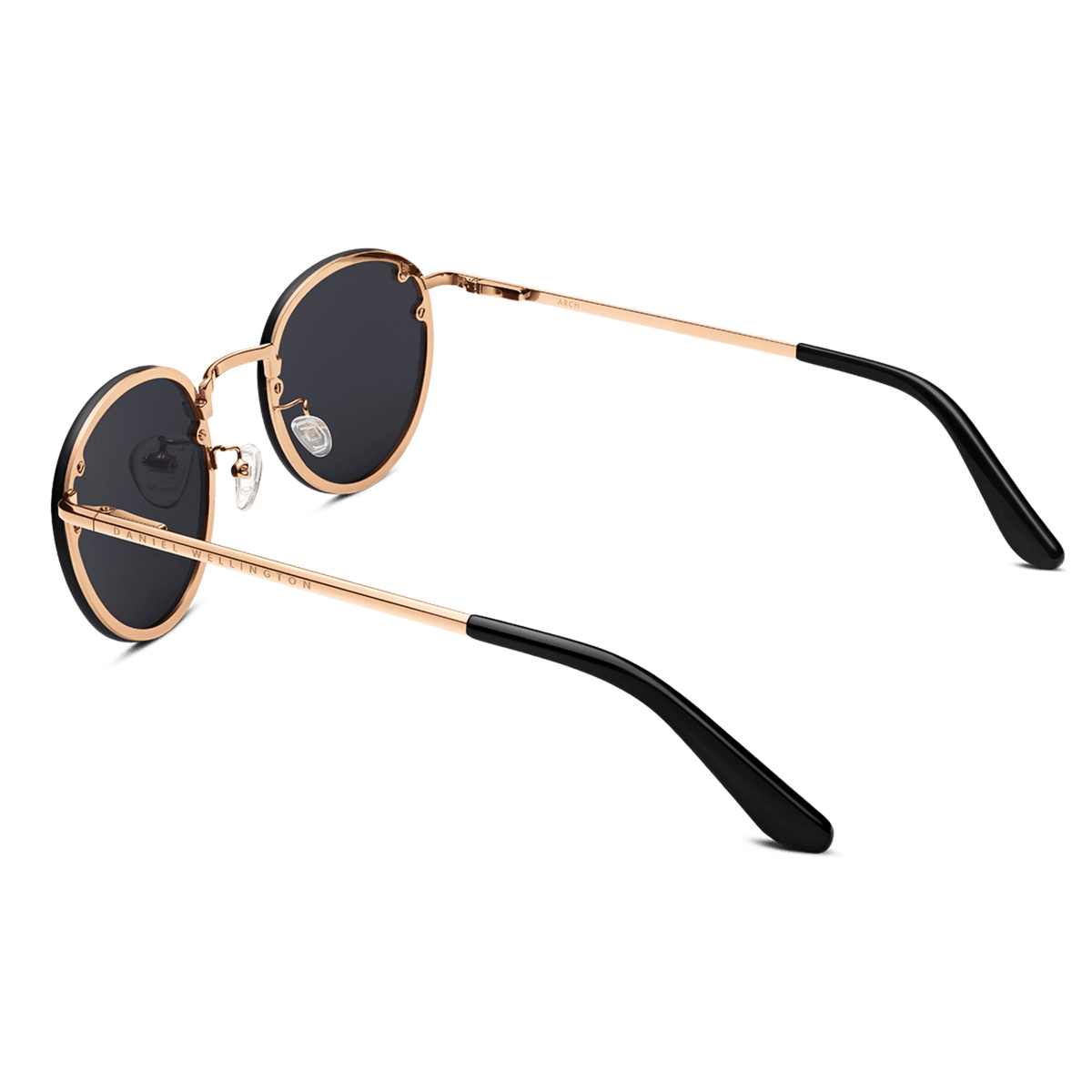 Arch Steel Black sunglasses featuring round black nylon lenses, a rose gold-plated stainless steel frame, and black acetate temple tips, viewed from the rear angle.