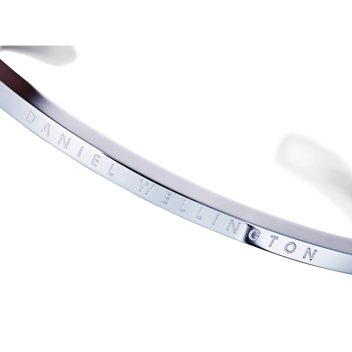 Close-up of the Classic Bracelet Silver showing its polished stainless steel surface and finely engraved Daniel Wellington logo.