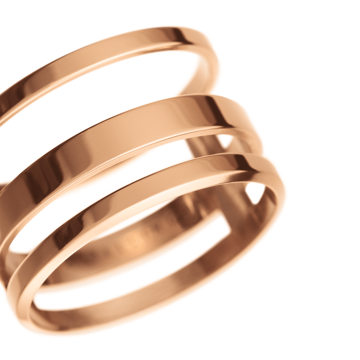 Close-up of the Elan Triad Ring in rose gold, highlighting its polished triple-band design and smooth stainless steel finish.