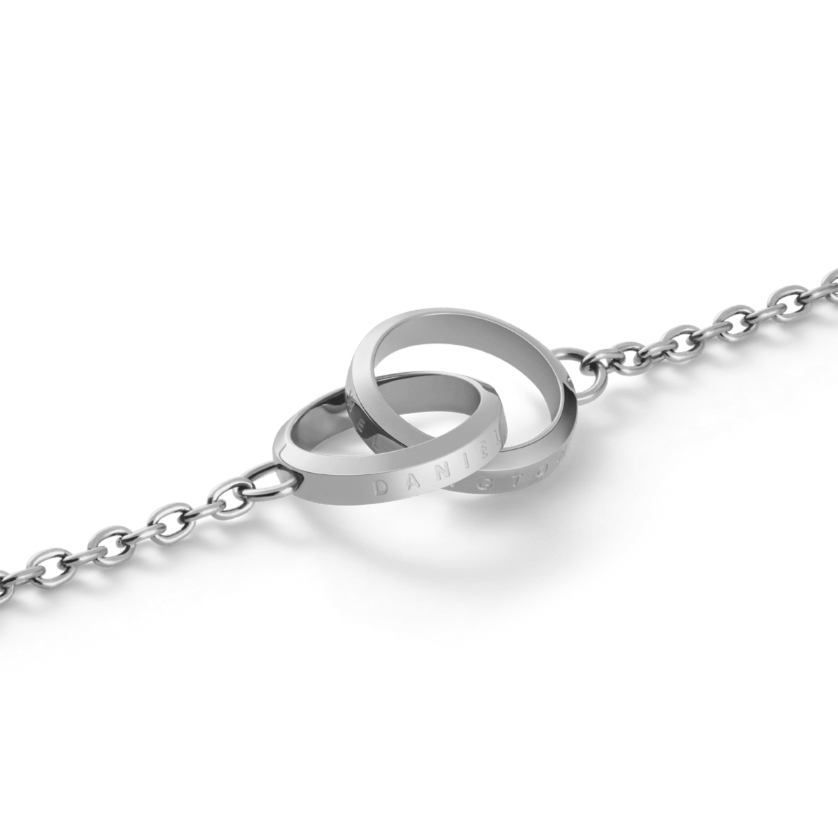 Close-up of the Daniel Wellington Elan Unity Bracelet showing two polished silver interlocking rings with subtle engraving on a fine chain.
