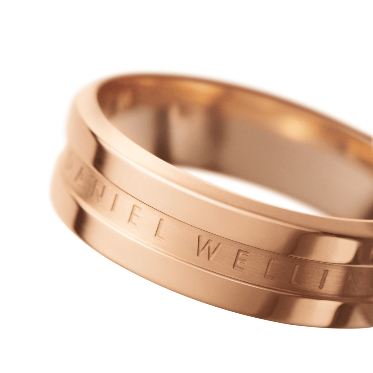 Close-up of the Elan Ring Rose Gold, highlighting its polished rose gold finish and the engraved Daniel Wellington logo on the sleek band.