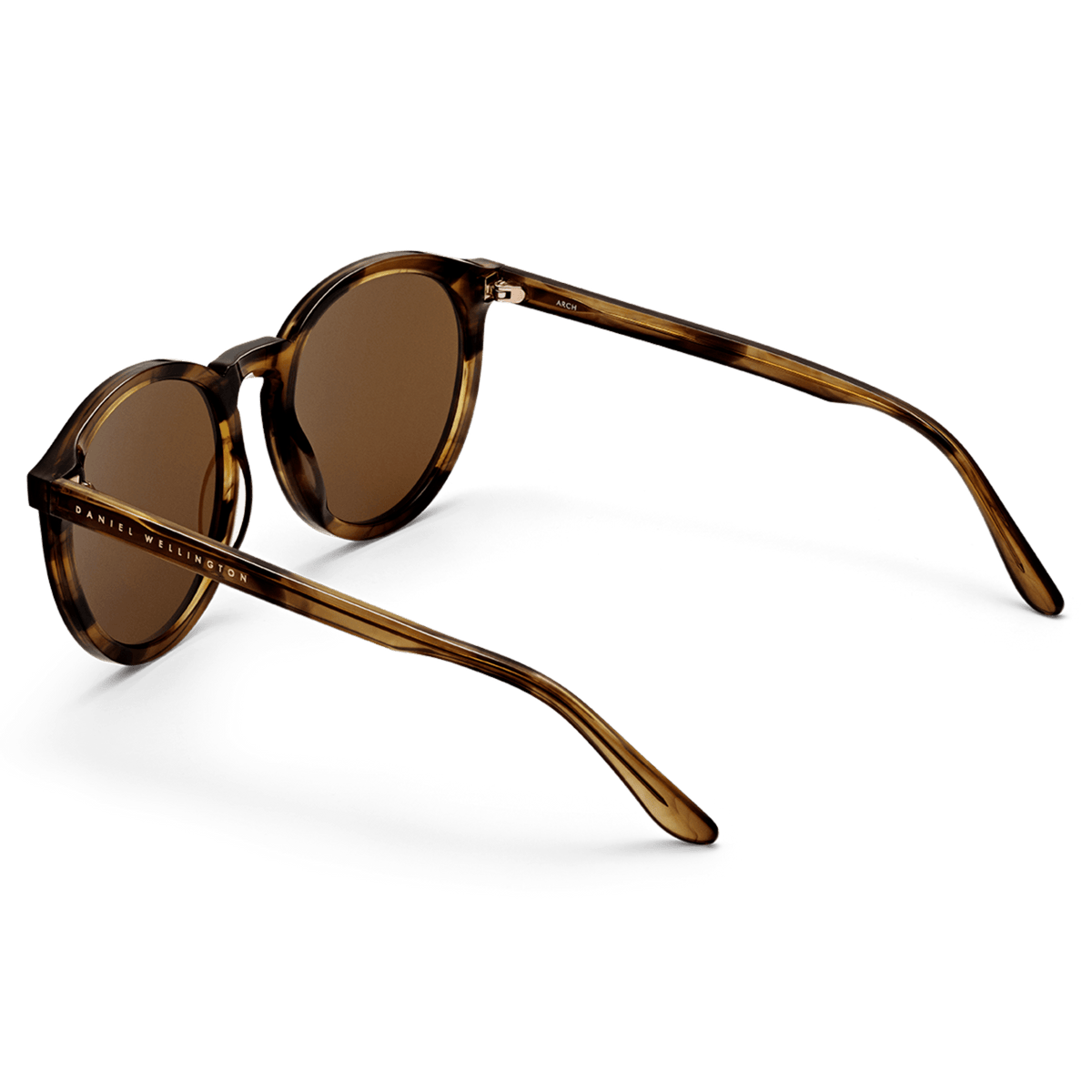 Bio-Acetate Arch Brown Demi sunglasses with round amber lenses, a lightweight tortoiseshell-effect frame, and Daniel Wellington branding on the arms.