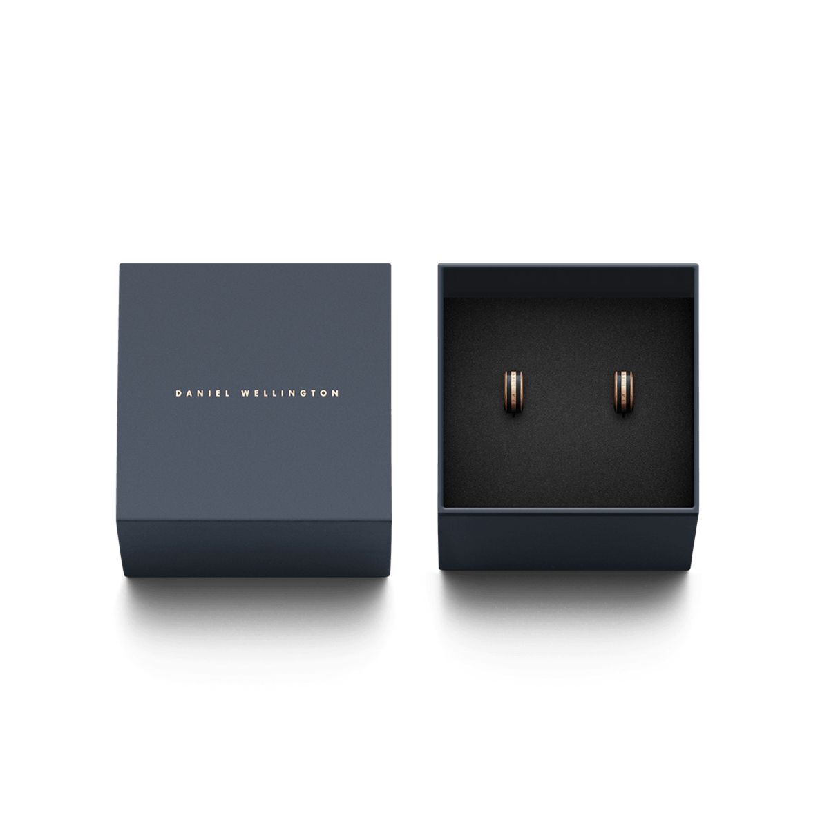 Emalie Earrings Rose Gold Black presented in a navy Daniel Wellington gift box, showcasing the elegant rose gold hoops with black enamel detailing.