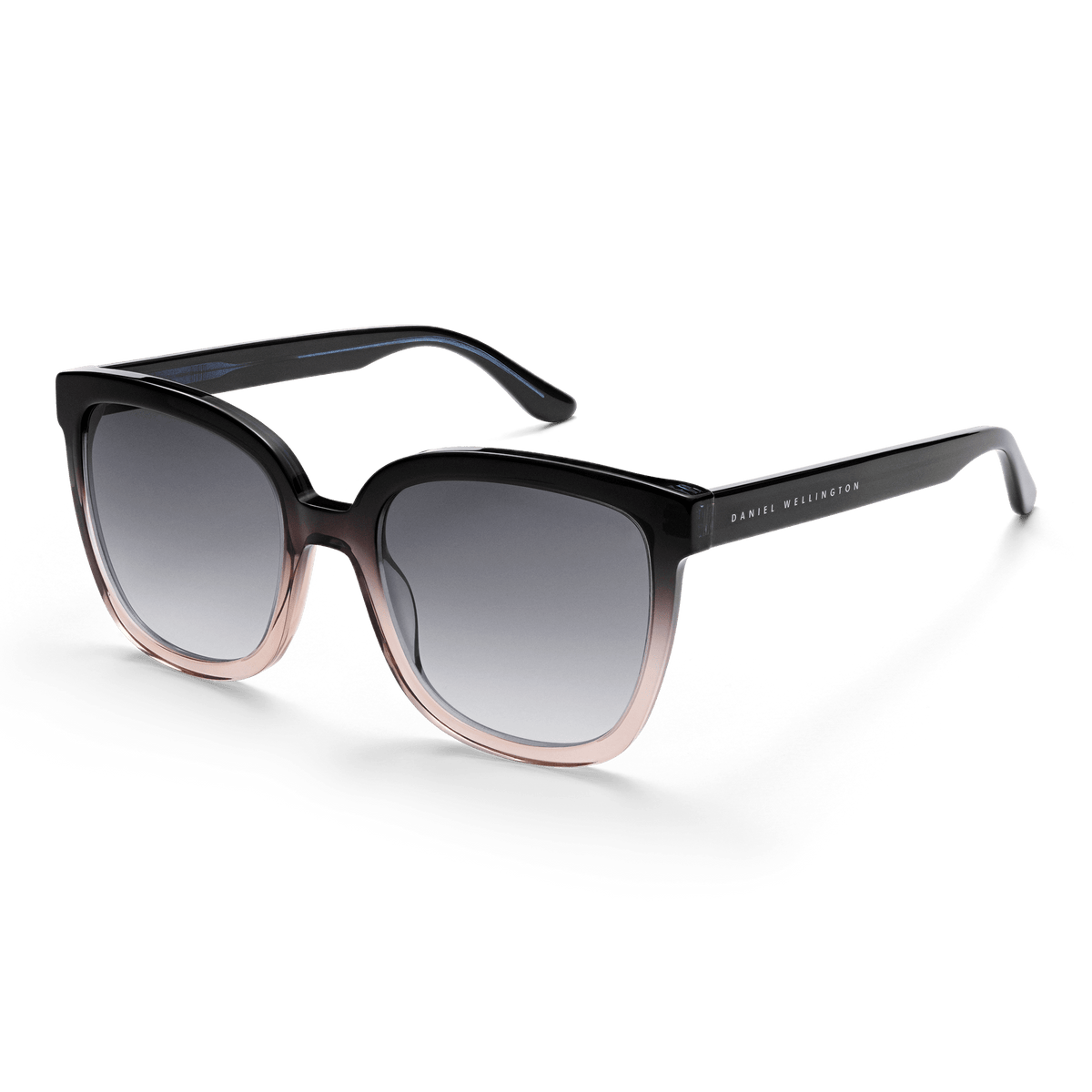Grande Bio-Acetate Blue Coral Blue sunglasses with oversized square frames in a blue, black, and coral gradient, featuring black gradient lenses and Daniel Wellington branding on the arm.