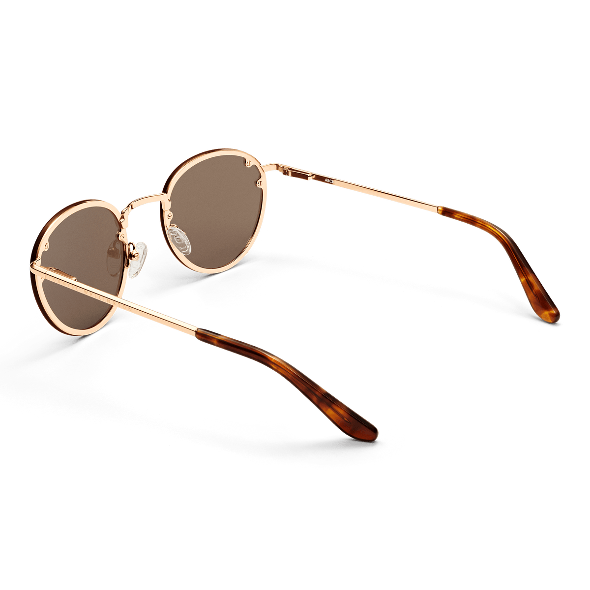 Arch Steel Brown Rose Gold sunglasses featuring round brown nylon lenses, a rose gold stainless steel frame, and tortoiseshell acetate temple tips.