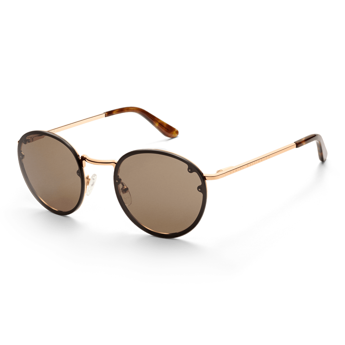 Round Arch Steel Brown Rose Gold sunglasses with a slim rose gold stainless steel frame, brown nylon lenses, and tortoiseshell acetate temple tips.