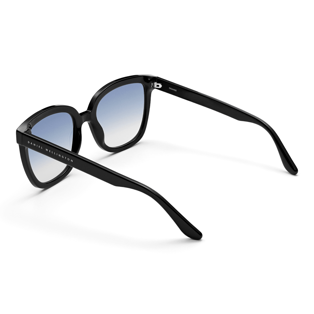 Grande Bio-Acetate Black Blue sunglasses with a bold black frame, blue gradient lenses, and Daniel Wellington branding along the arm, shown from a rear angle.