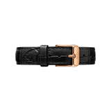 Croc-embossed black leather watch strap with a rose gold buckle and engraved branding, designed for a refined and versatile look.