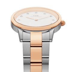 Daniel Wellington Iconic Link Lumine watch featuring a round case with a rose gold bezel, crystal-set white dial, and a two-tone stainless steel and rose gold-plated bracelet.