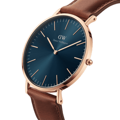 Classic St Mawes Arctic Rose Gold watch with a polished rose gold case, deep blue sunray dial, minimalist markers, and a smooth brown leather strap. The elegant design highlights the refined contrast between the blue face and warm rose gold detailing.