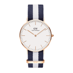 Classic Glasgow Rose Gold watch with a slim rose gold case, minimalist white dial, and a navy and white striped NATO strap.