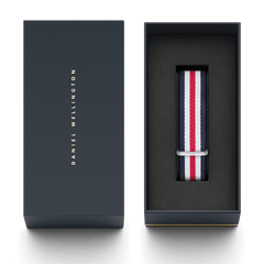Daniel Wellington Canterbury Strap Silver with navy, white, and red stripes, presented in a sleek black gift box with gold lettering, ideal as a stylish and practical watch strap upgrade.