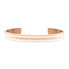 Slim rose gold cuff bracelet with a satin white enamel inlay and Daniel Wellington logo engraved along the profile.