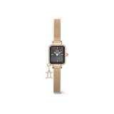 Gold rectangular women’s watch with a black mother of pearl dial, crystal-set bezel, gold mesh strap, and a sparkling Gemini zodiac charm attached.