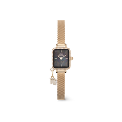 Gold women’s watch with a rectangular crystal-framed case, black mother of pearl dial, gold mesh strap, and a sparkling Capricorn zodiac charm.