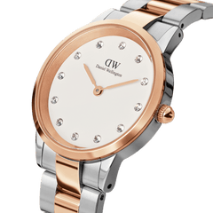 Close-up of the Daniel Wellington Iconic Link Lumine watch, showcasing its eggshell white dial with crystal indexes and a polished two-tone stainless steel and rose gold-plated bracelet.