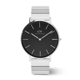 Classic Daniel Wellington watch with a brushed onyx black dial and a distinctive silver piano link strap, featuring minimalist hour markers and a sleek stainless steel finish.