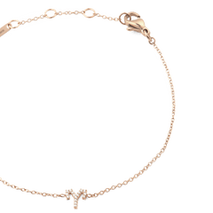 Delicate rose gold chain bracelet with a sparkling Aries zodiac pendant and adjustable sizing rings.