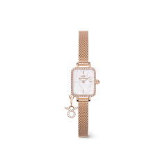 Rose gold women’s watch with a rectangular crystal-framed case, white mother of pearl dial, and a mesh strap featuring a sparkling zodiac charm. The petite and elegant design highlights refined details and a personal touch.