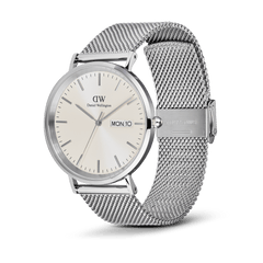 Classic Day Display Sterling Champagne watch with a round silver stainless steel case, champagne dial featuring a subtle triangle pattern, day and date window, and an adjustable silver mesh strap with a secure clasp.