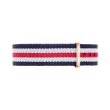 Striped navy blue, white, and red NATO watch strap with a polished rose gold buckle, designed for Daniel Wellington watches and crafted from durable polyester fabric.