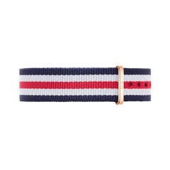 Striped navy blue, white, and red NATO watch strap with a polished rose gold buckle, designed for Daniel Wellington watches and crafted from durable polyester fabric.