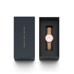Petite Lumine Bezel Melrose Pink MOP watch with a pink mother of pearl dial and rose gold mesh strap, elegantly presented in a dark Daniel Wellington gift box.
