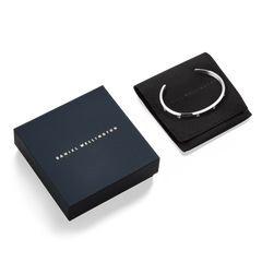 Classic Lumine Bracelet Silver 5.5mm displayed on a black pouch beside a navy Daniel Wellington gift box, highlighting its polished silver finish and sparkling cubic zirconia crystal accents, ideal for gifting.