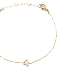 Close-up of a gold crystal zodiac chain bracelet featuring an adjustable clasp and a sparkling zodiac pendant on a fine chain.