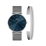 Silver Daniel Wellington watch with a deep blue minimalist dial and mesh strap, paired with a polished silver Elan bracelet engraved with the brand’s name. This elegant set combines contemporary style with classic design, ideal for both everyday wear and special occasions.