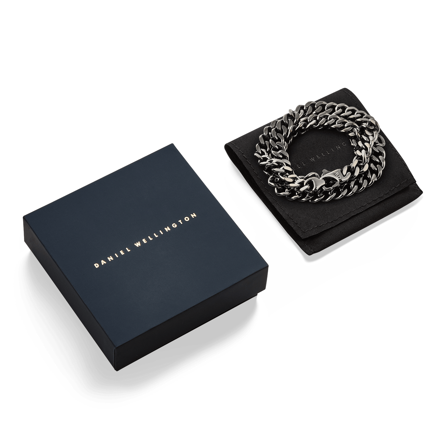 Ellipse Cuban Chain Necklace in graphite, presented coiled on a black display pad next to a signature Daniel Wellington gift box, highlighting its polished Cuban links and elegant packaging.