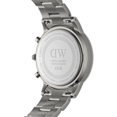 Back view of the Daniel Wellington Iconic Chronograph Link Graphite watch, showing the engraved stainless steel case back, brushed link bracelet, and detailed branding.