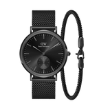 Sleek black Daniel Wellington watch with a minimalist multi-eye dial and matching black mesh strap, paired with a coordinating black bracelet for a refined, modern look.