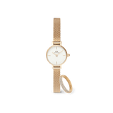 Petite gold mesh strap watch with a minimalist white dial, paired with a delicate pavé crystal ring featuring sparkling stones and a matching gold finish.