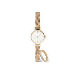 Petite gold mesh strap watch with a minimalist white dial, paired with a delicate pavé crystal ring featuring sparkling stones and a matching gold finish.