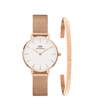 Rose gold Petite Melrose watch with a minimalist white dial and mesh strap, paired with a matching polished cuff bracelet featuring subtle Daniel Wellington branding.