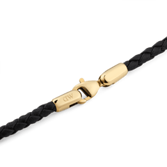 Detail view of the Daniel Braided Leather Bracelet Sheffield 2.8 Gold, showing the slim black braided leather band with a polished gold-tone lobster clasp engraved with the DW logo.