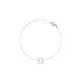 Delicate silver chain bracelet featuring an adjustable fit and a Gemini zodiac charm set with sparkling cubic zirconia crystals.