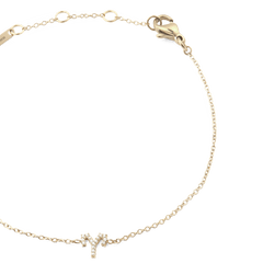 Close-up of the Crystal Zodiac Chain Bracelet Gold with an Aries pendant set with sparkling crystals and an adjustable gold chain.