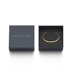 Classic Lumine Bracelet G presented in an elegant Daniel Wellington gift box, showcasing the slim gold cuff with sparkling crystals and subtle DW engraving.